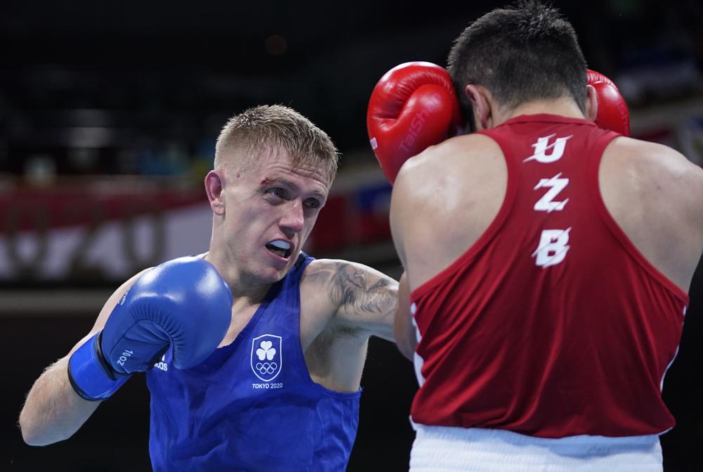 Ireland's Kurt Anthony Walker punches Uzbekistan's Mirazizbek Mirzakhalilov during the men's featherweight 57-kg boxing match at the 2020 Summer Olympics, Wednesday, July 28, 2021, in Tokyo, Japan. Ireland's Kurt Anthony Walker punches Uzbekistan's Mirazizbek Mirzakhalilov during the men's featherweight 57-kg boxing match at the 2020 Summer Olympics, Wednesday, July 28, 2021, in Tokyo, Japan.