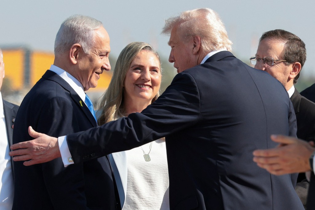 Israeli Prime Minister Benjamin Netanyahu reacts next to U.S. President Donald Trump at Ben Gurion International Airport, amid a U.S.-brokered prisoner-hostage swap and ceasefire deal between Israel and Hamas, in Lod, Israel, October 13, 2025. (Reuters)