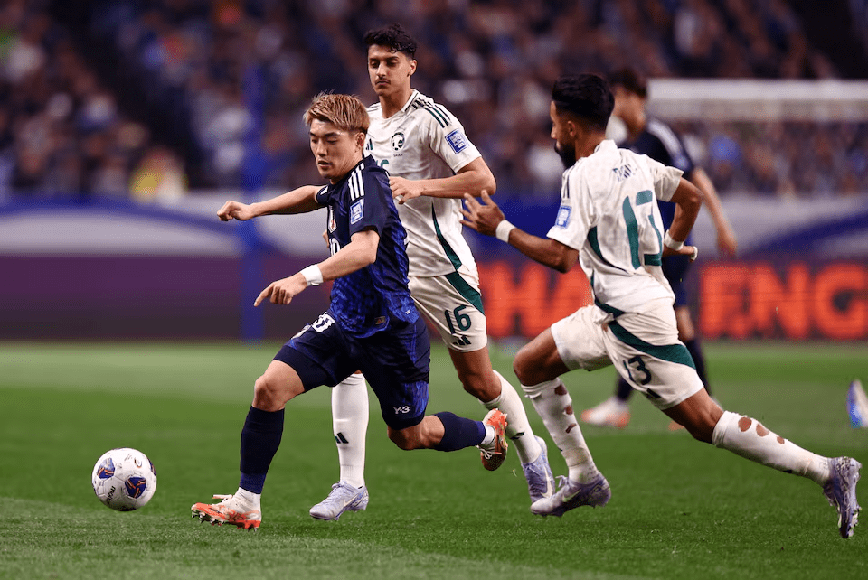 Soccer Football - World Cup - AFC Qualifiers - Third Round - Group A - Japan v Saudi Arabia - Saitama Stadium, Saitama, Japan - March 25, 2025 Japan's Ritsu Doan in action with Saudi Arabia's Nawaf Boushal and Faisel Al-Ghamdi REUTERS/Issei Kato/File Photo