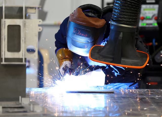 A welder works in the welding bay at Rheinmetall Bae Systems Land (RBSL) where production of the new mechanised infantry vehicle begins in Telford, Britain, March 27, 2023. REUTERS/Molly Darlington/File Photo