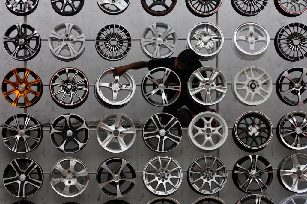 A worker displays alloy wheels for sale in India's Hyderabad. REUTERS/Krishnendu Halder/File Photo 