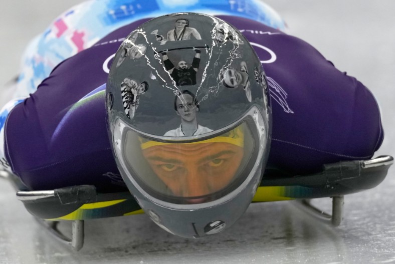 Pictures of Ukrainian athletes killed in the war with Russia are shown on Vladeslav Heraskevych’s helmet. AP