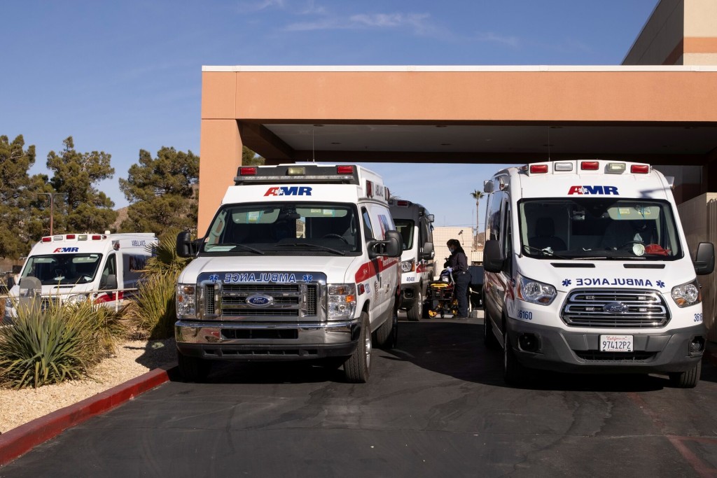 Six ambulances are parked at the emergency entrance to St. Mary Medical Center, California, U.S., January 12, 2021. REUTERS/Mike Blake