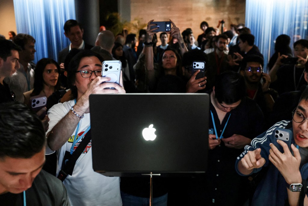 People take photos of the new MacBook Pro with a touch screen following the launch by Apple CEO John Ternus in Los Angeles, California, US, October 28, 2026. REUTERS