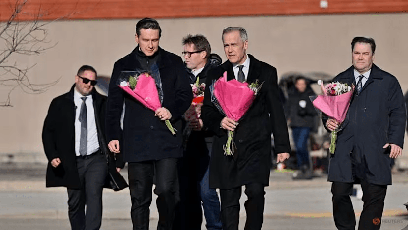 Canada's Prime Minister Mark Carney, Conservative leader Pierre Poilievre, and NDP interim leader Don Davies visit a makeshift memorial, three days after one of the worst mass shootings in recent Canadian history, in the town of Tumbler Ridge, British Columbia, on Feb 13, 2026. (Photo: REUTERS/Jennifer Gauthier)