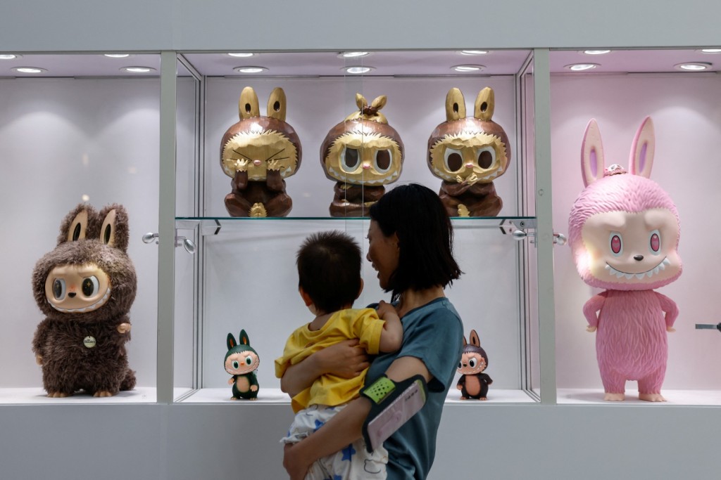 Visitors view a set of three Labubu sculptures from a series called 'Three Wise Labubu' at a preview exhibition of Yongle International Auction in Beijing. The set was later sold for 510,000 yuan. Photo by REUTERS