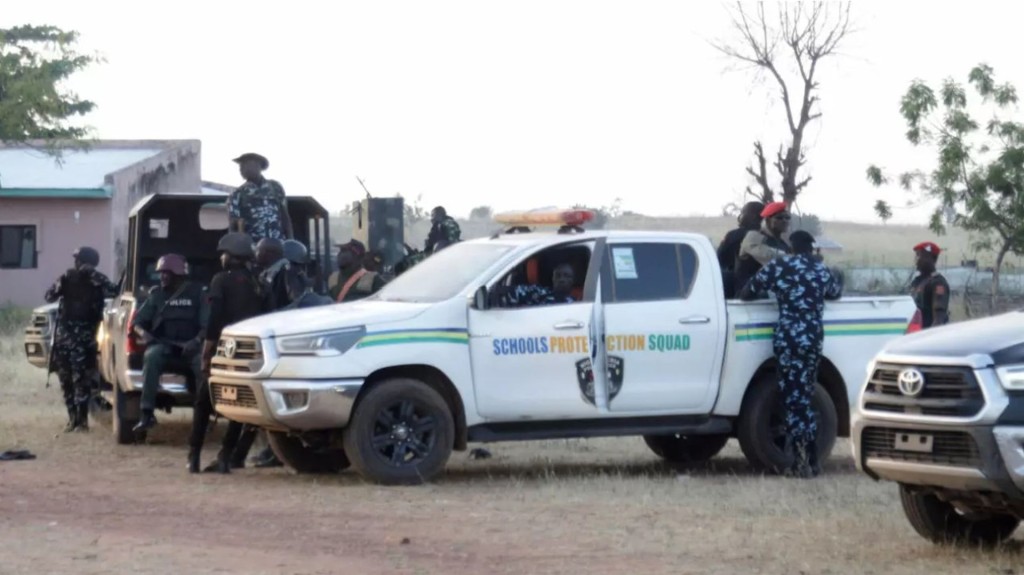 Police officers stand guard outside a school in Nigeria's Kebbi state, where pupils were kidnapped earlier this week. AP