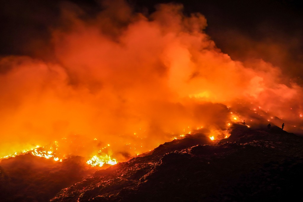 Photo by DITO / AFP  This picture taken on August 6, 2026 shows a fire burning at a landfill site in Rasau Jaya, Kubu Raya, West Kalimantan.
