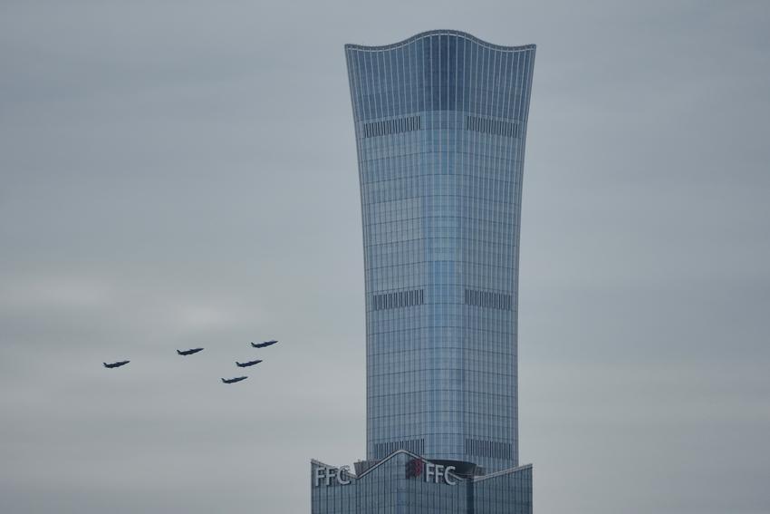 Chinese J-20 stealth fighter jets fly past Beijing's tallest skyscraper, China Zun Tower during a rehearsal ahead of the Sept 3 military parade to commemorate the 80th anniversary of Japan's World War II surrender, in Beijing on Sunday,  (AP/Andy Wong)