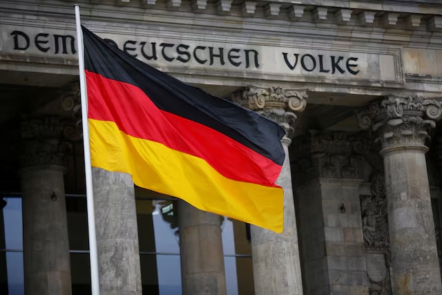 The German flag is seen outside Germany's Bundestag, the lower house of parliament. in Berlin, Germany, March 14, 2018. REUTERS/Hannibal Hanschke