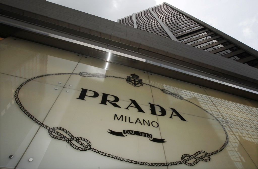 The Prada logo is seen outside its store in Hong Kong in this June 6, 2011 file photograph. Italian fashion house Prada SpA beat forecasts with a 30 percent rise in third-quarter net profit, shrugging off concerns about a slowdown in demand for luxury goods. The company, led by trend-setting designer Miuccia Prada and her husband Bertelli, posted a net profit of 122.1 million euros ($160 million) in the third quarter, boosted by wealthy spenders from Asia and other emerging markets.  REUTERS/Bobby Yip/Files