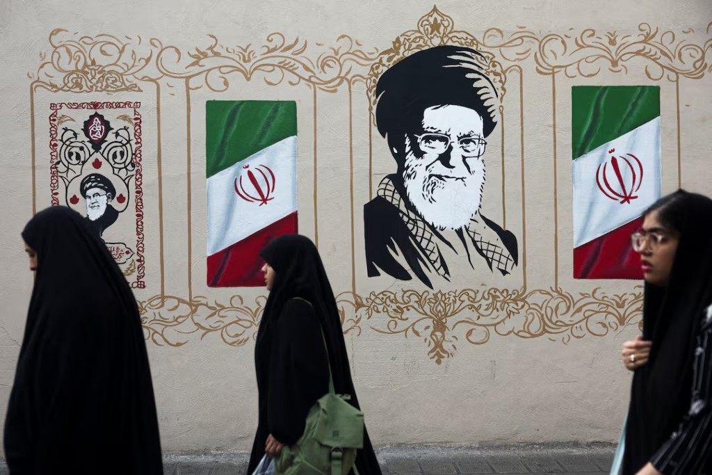 People walk by a mural depicting Iran's late Supreme Leader Ayatollah Ali Khamenei, on a street in Tehran, Iran, August 13, 2026. Majid Asgaripour/WANA (West Asia News Agency) via REUTERS/File Photo