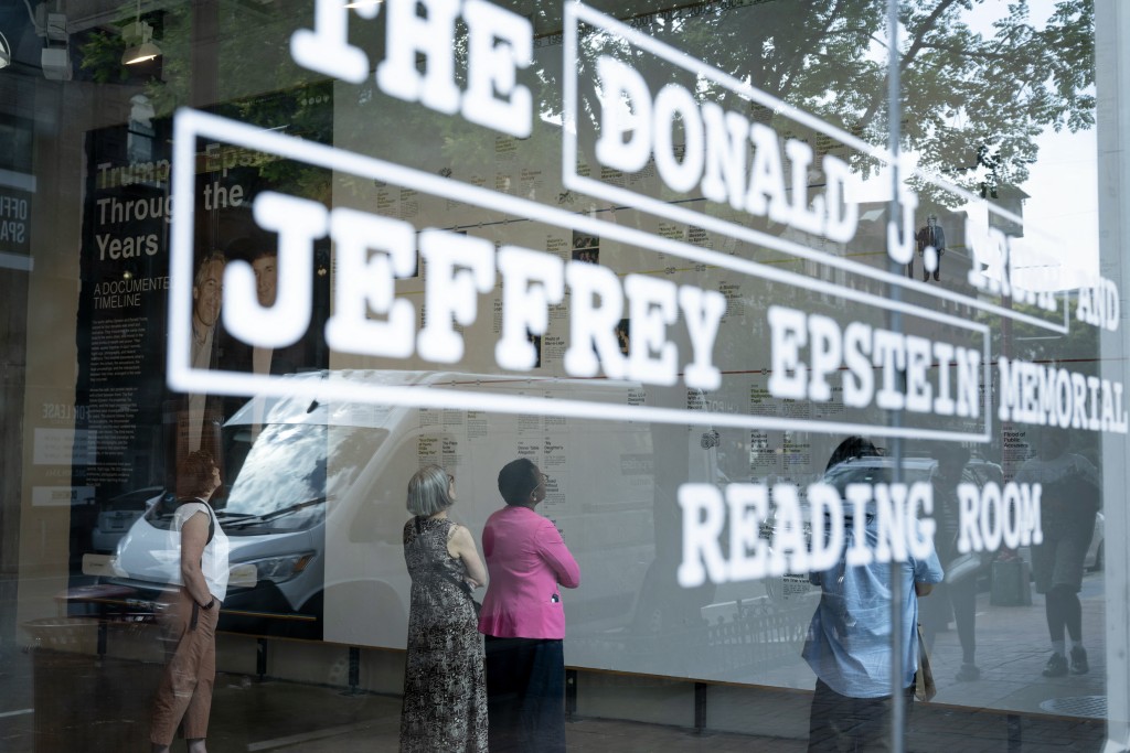 People visit the pop-up exhibit "Donald J. Trump and Jeffrey Epstein Memorial Reading Room" where 3,437 bound volumes of the "Epstein Files" are on display in Washington, DC, on June 9, 2026. (Photo by Brendan Smialowski / AFP)