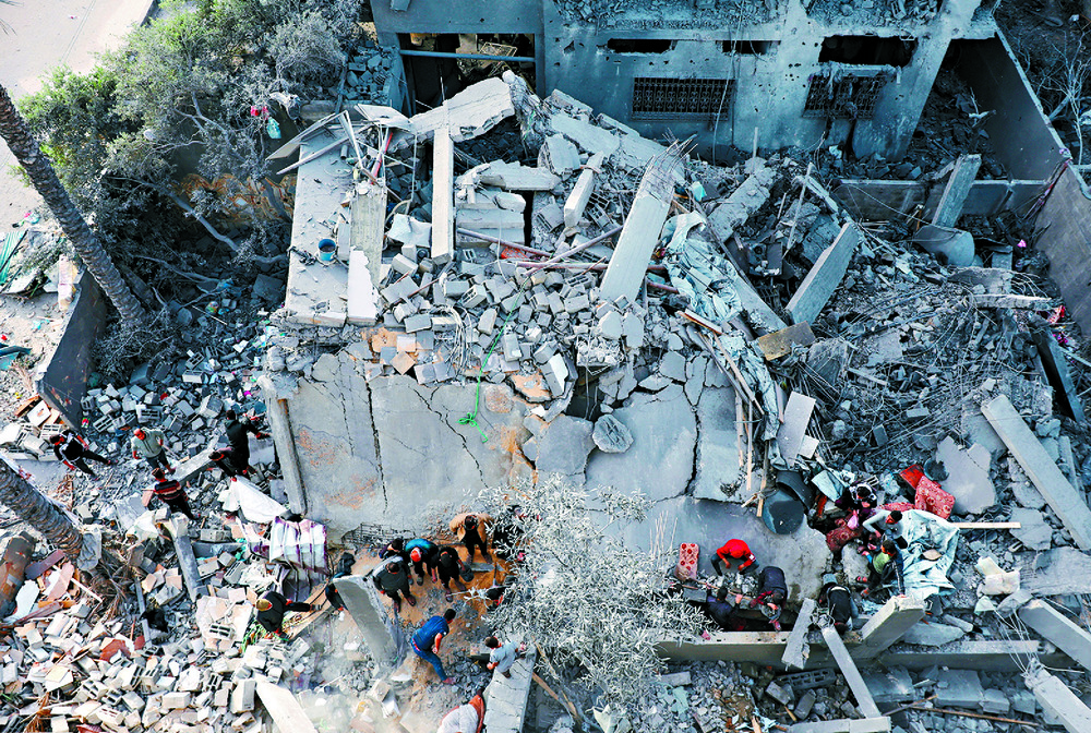 Palestinians inspect the site of an Israeli strike on a house in the central Gaza Strip. Reuters Palestinians inspect the site of an Israeli strike on a house in the central Gaza Strip. Reuters