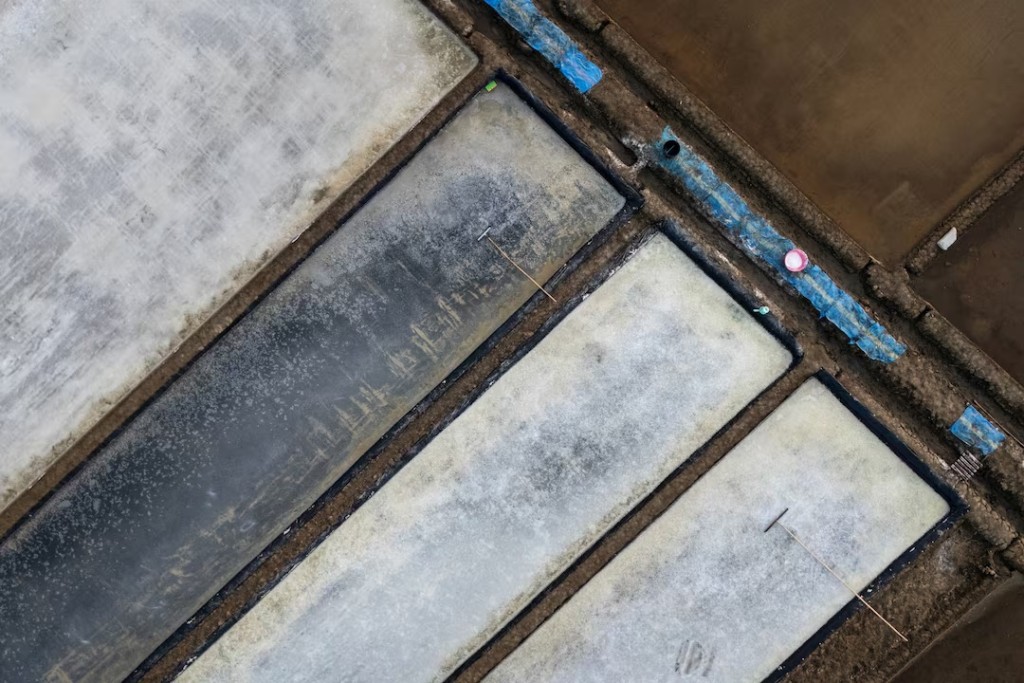 A drone view shows crystallised salt on the pond floors during harvest in Pengarengan village, Cirebon, West Java province, Indonesia, July 30, 2026. REUTERS/Willy Kurniawan