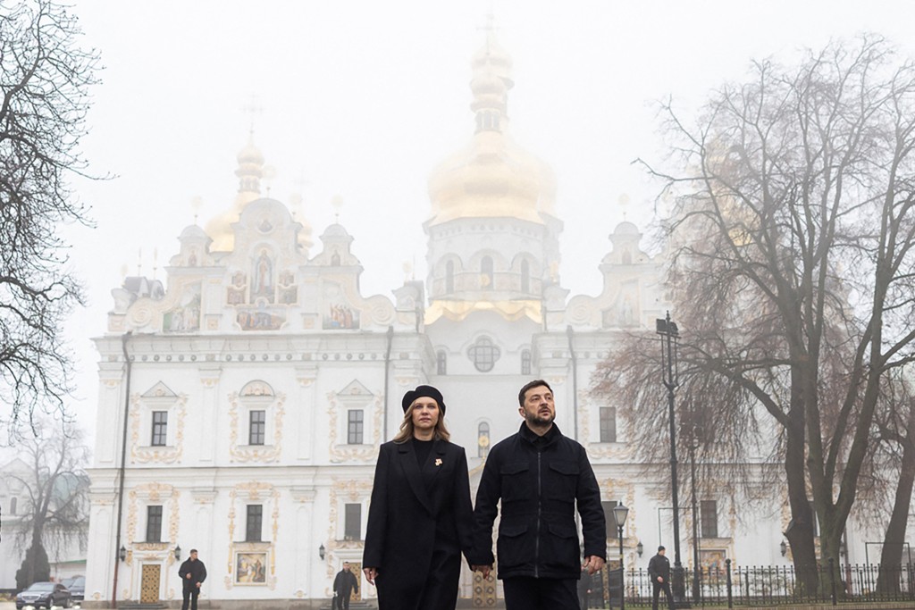 Ukraine's President Volodymyr Zelensky (R) and his wife Olena Zelenska (L) walk in front of the Dormition Cathedral of the Kyiv Pechersk Lavra Monsatery. (AFP)