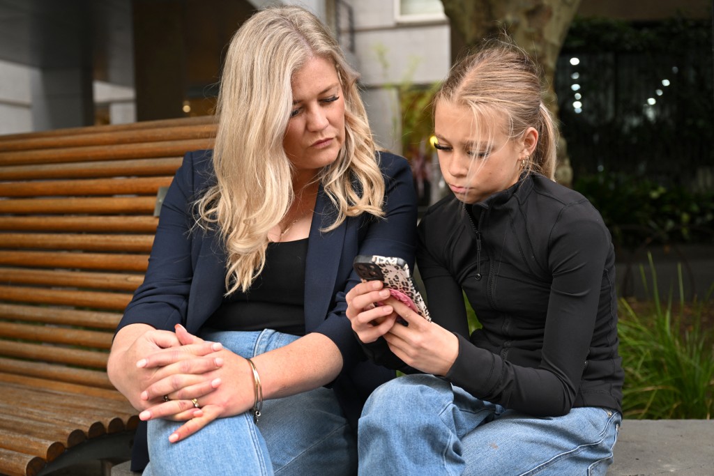 Photo by WILLIAM WEST / AFP  A photo taken on November 18, 2025 shows Zoe Jones with her 12-year-old influencer daughter Ava in Melbourne.