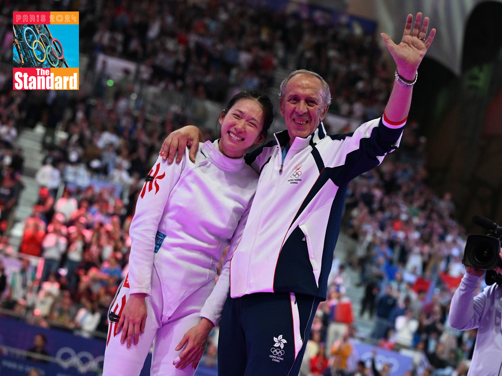 Vivian Kong Man-wai celebrates with her coach Octavian Zidaru after winning the gold medal. (Photo from International Fencing Federation)