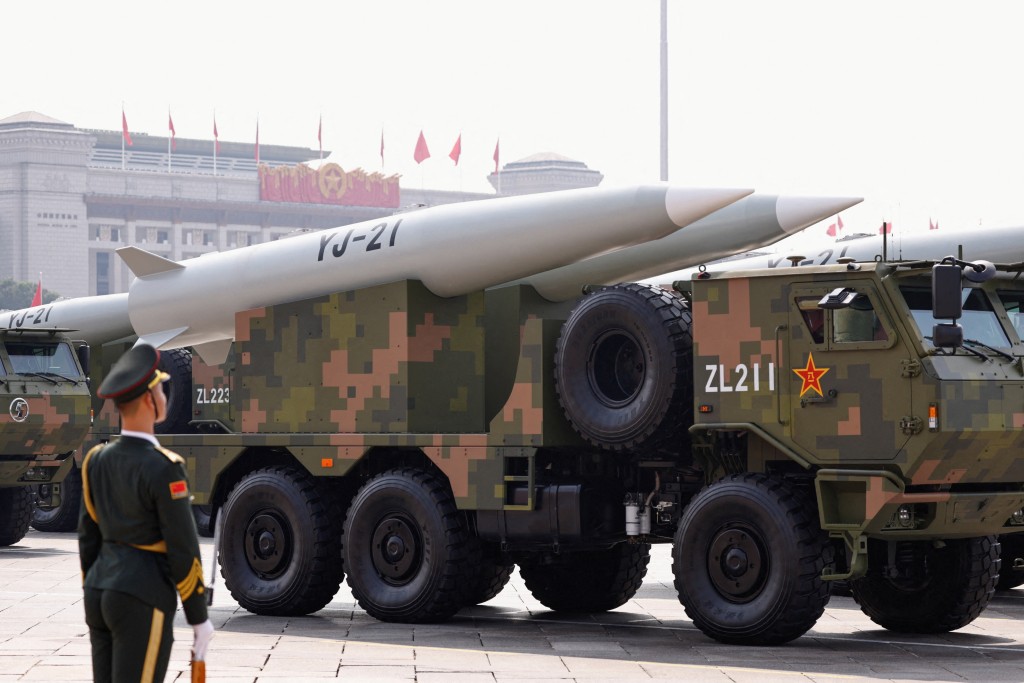 A member of the People's Liberation Army stands as the strategic strike group displays YJ-21 missiles during a military parade to mark the 80th anniversary of the end of World War Two, in Beijing, China, September 3. (Reuters)