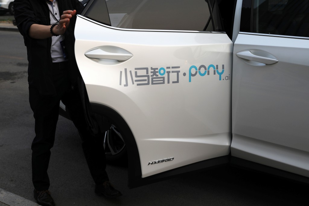 A member of the media steps off a Lexus vehicle equipped with Pony.ai's autonomous driving system during a test event, in Beijing, China May 13, 2021. REUTERS/Tingshu Wang