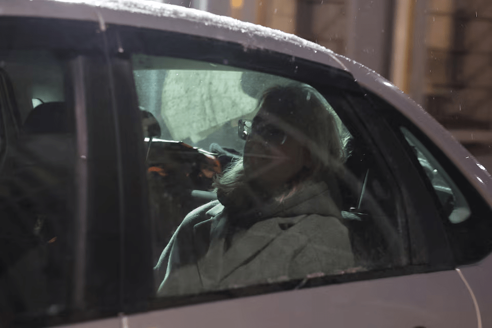 Diana Loginova, a teenage street musician performing under the name Naoko and singing in the Stoptime group who served three short jail stints for singing anti-Kremlin songs, sits in a car as she is escorted out of a temporary detention facility after her latest 13-day jail period ended in Saint Petersburg, Russia November 23, 2025. REUTERS/Anton Vaganov
