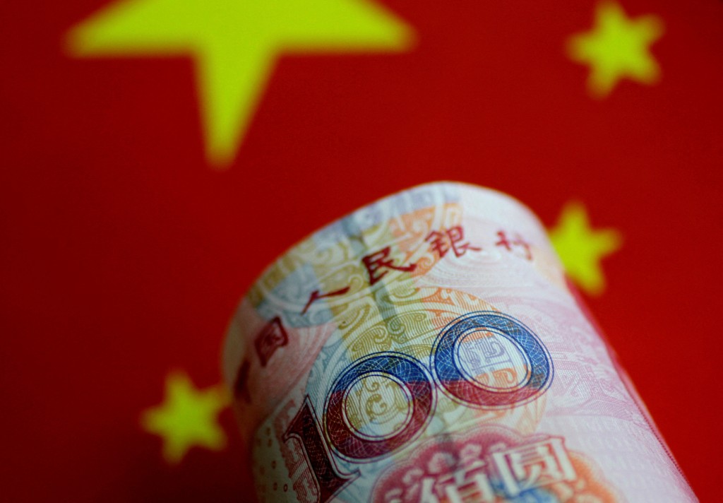 China yuan and Chinese flag. REUTERS