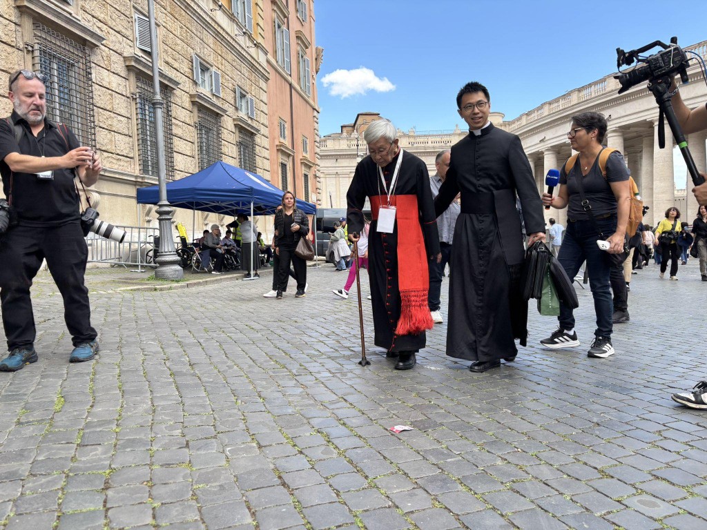 (pic from zen's Facebook) Zen walks through St. Peter's Square with the assistance of priest Carlos Cheung.