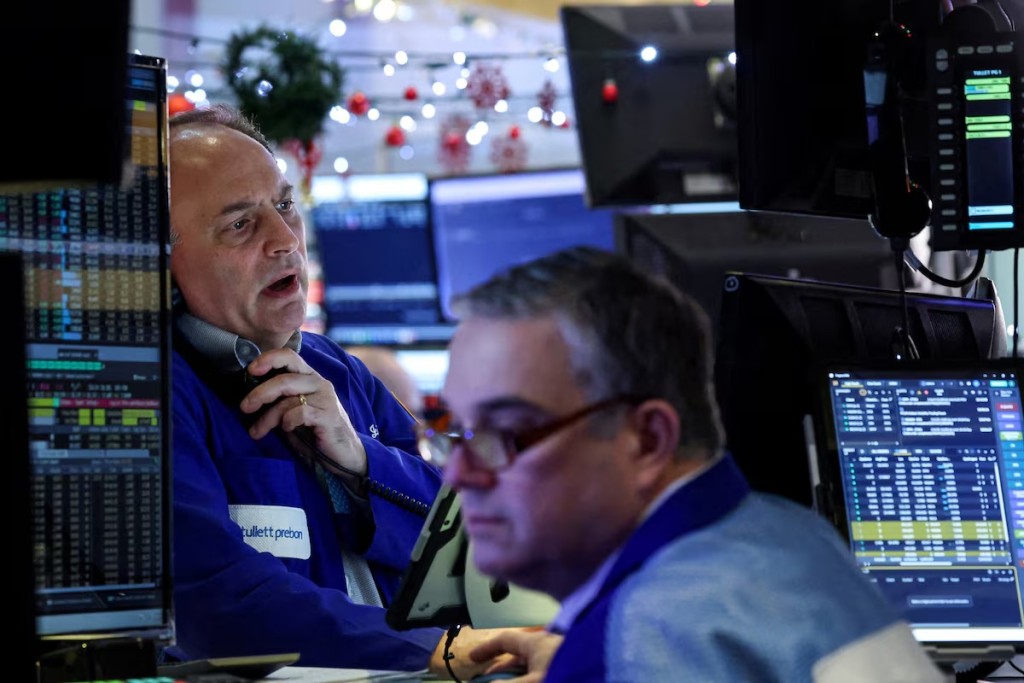 Traders work on the floor at the New York Stock Exchange (NYSE) in New York City, U.S., December 17, 2025. REUTERS