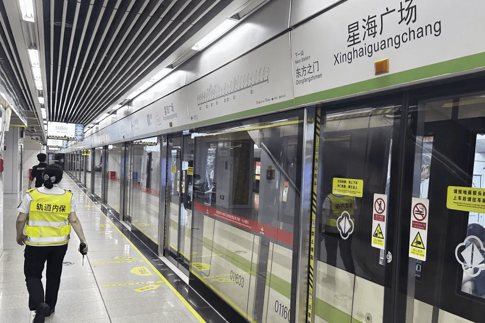 Security personnel walk at a subway station platform in Suzhou, eastern China, where a Japanese woman living in China was reported to be attacked and injured on Thursday by a man, Friday, Aug. 1, 2025. (Kyodo News via AP)