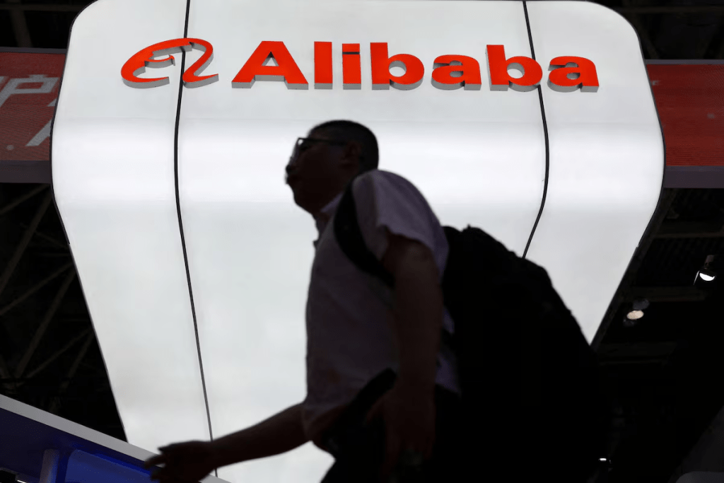 A man walks past the Alibaba logo displayed at its booth during the China International Supply Chain Expo in Beijing, China July 16, 2025. REUTERS/Florence Lo/File Photo
