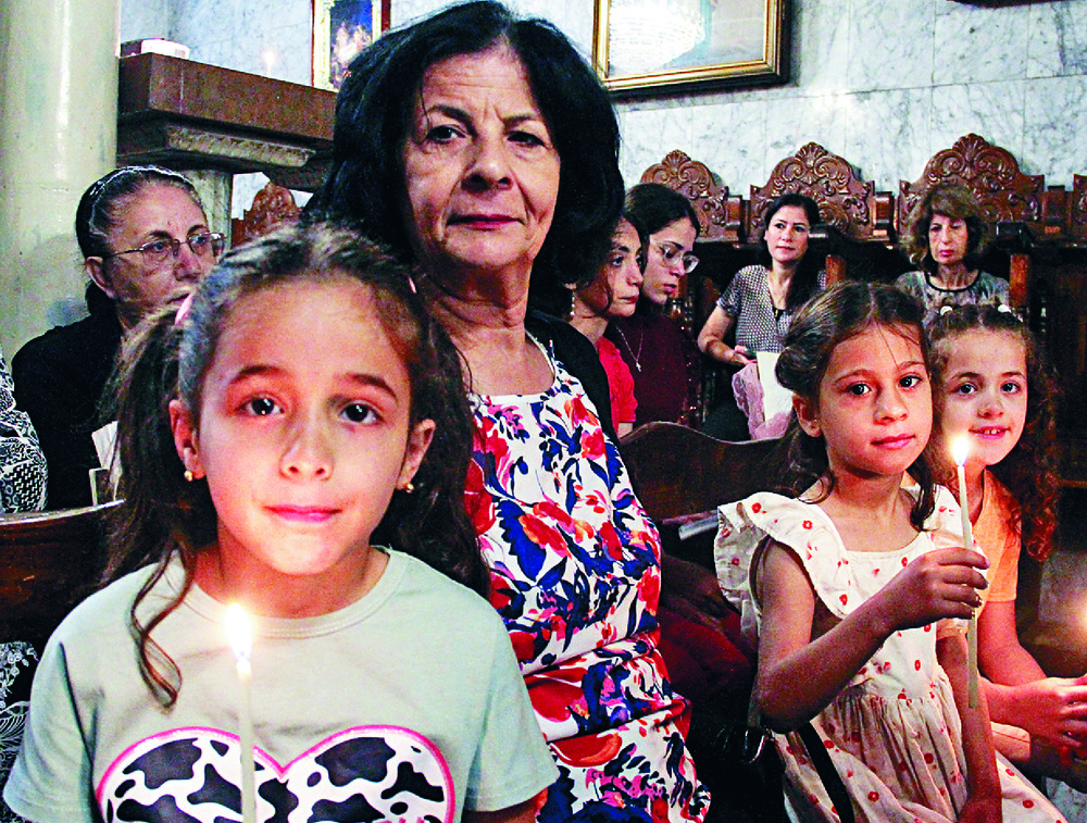 Christian Palestinians attend an Orthodox Easter mass in Gaza City. Christian Palestinians attend an Orthodox Easter mass in Gaza City.