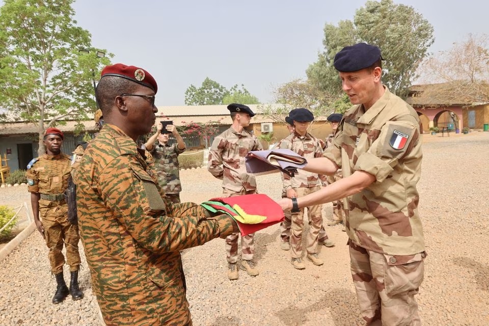 Head of Burkina Faso's army Colonel Adam Nere receives a flag from French Lieutenant-Colonel Louis Lecacheur during a military handover ceremony to officially mark the end of French military operations on Burkinabe soil, at the base of Kamboincin, Burkina Faso February 18, 2023. (Burkina Faso's General Staff of the Armed Forces/Handout via REUTERS) Head of Burkina Faso's army Colonel Adam Nere receives a flag from French Lieutenant-Colonel Louis Lecacheur during a military handover ceremony to officially mark the end of French military operations on Burkinabe soil, at the base of Kamboincin, Burkina Faso February 18, 2023. (Burkina Faso's General Staff of the Armed Forces/Handout via REUTERS)