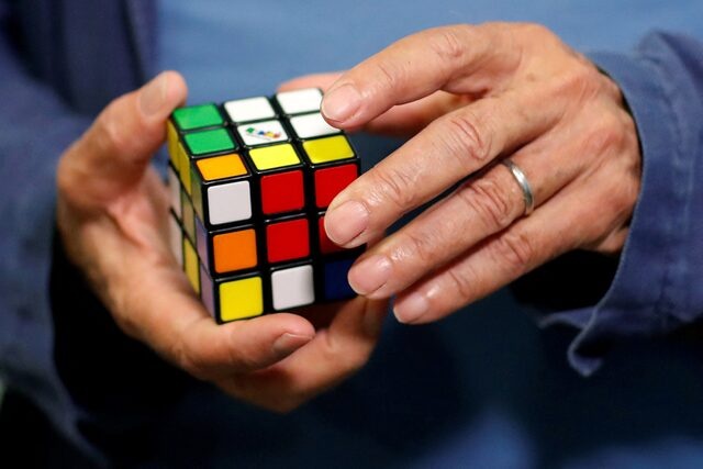 Erno Rubik, the creator of the puzzle, solves a Rubik's cube as he poses during the world's largest Rubik's Cube championship in Aubervilliers, near Paris, France, July 15, 2017. REUTERS/Stephane Mahe/File Photo