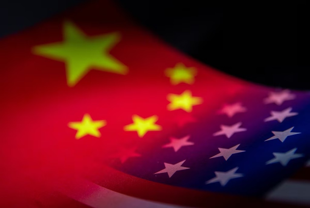 China's and U.S.' flags are seen printed on paper in this illustration taken January 27, 2022. REUTERS