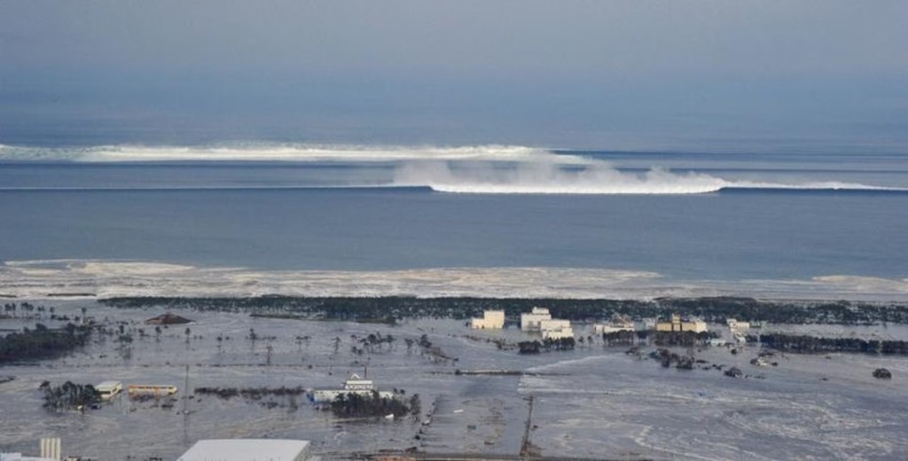 The oncoming tsunami strikes the coast in Natori City, Miyagi Prefecture, northeastern Japan, March 11, 2011. REUTERS/KYODO
