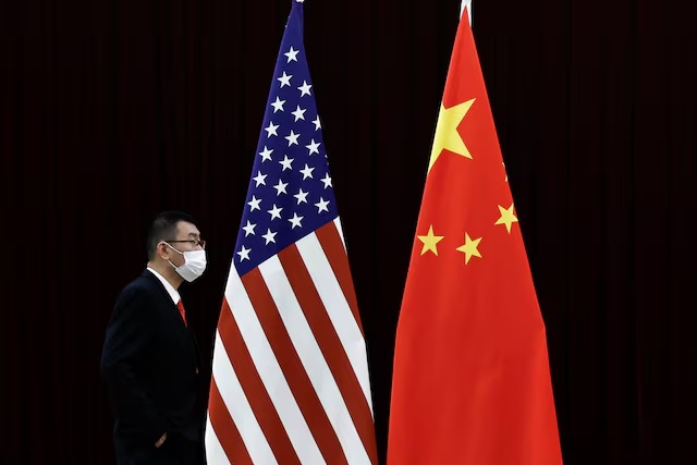 A man walks past the national flags of China and the U.S. in Guangzhou, Guangdong province, China, April 6, 2024. REUTERS/Tingshu Wang/File Photo A man walks past the national flags of China and the U.S. in Guangzhou, Guangdong province, China, April 6, 2024. REUTERS/Tingshu Wang/File Photo