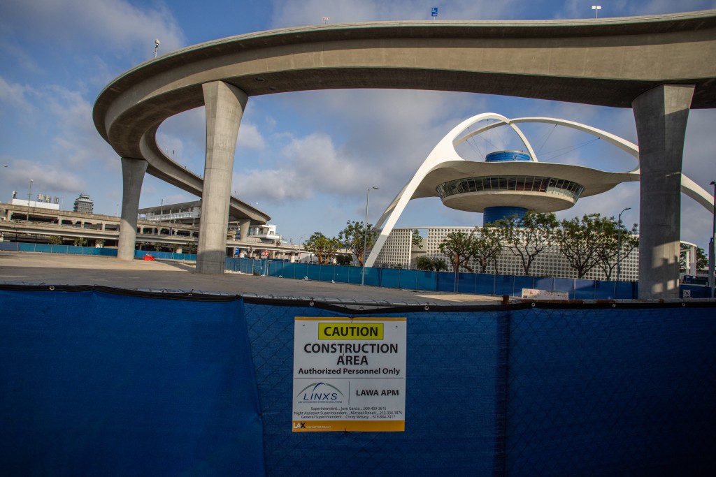 Photo by APU GOMES / AFP  A closed construction area is seen near The SkyLink Automated People Mover line and the Theme Building and Air Traffic Control Tower at Los Angeles International Airport (LAX) in Los Angeles, California, on May 15, 2026.