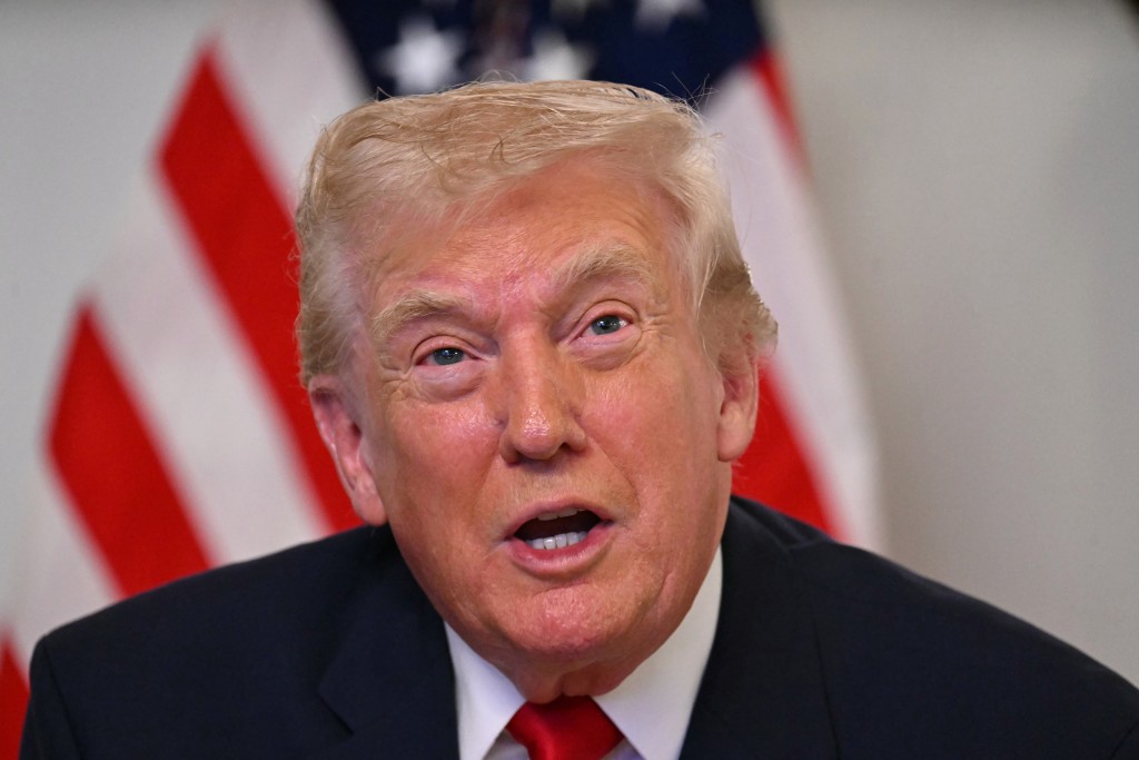 Photo by JIM WATSON / AFP  US President Donald Trump participates in a video call with military service members from his Mar-a-Lago residence in Palm Beach, Florida, on November 27, 2025, during the Thanksgiving holiday.