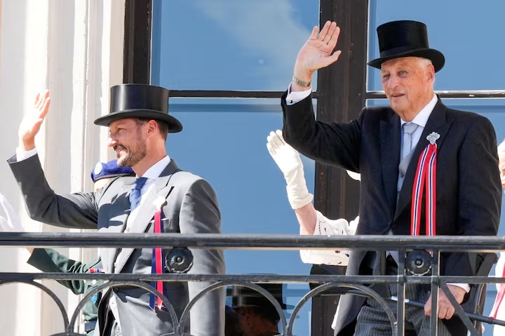 Norway's King Harald and Crown Prince Haakon greet the children's train from the Castle Balcony at the Castle, in Oslo, Norway, May 17, 2024. NTB/Heiko Junge/via REUTERS/File Photo 