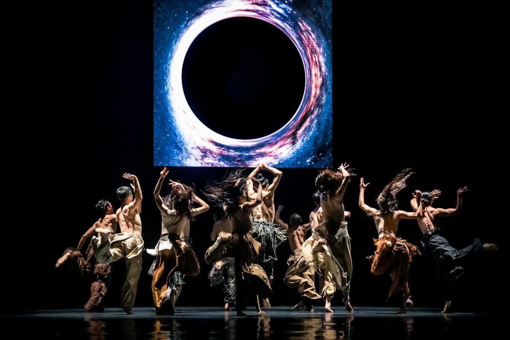 The dancers' raw movements are set against a surreal, celestial background. LEE CHIA-YEH