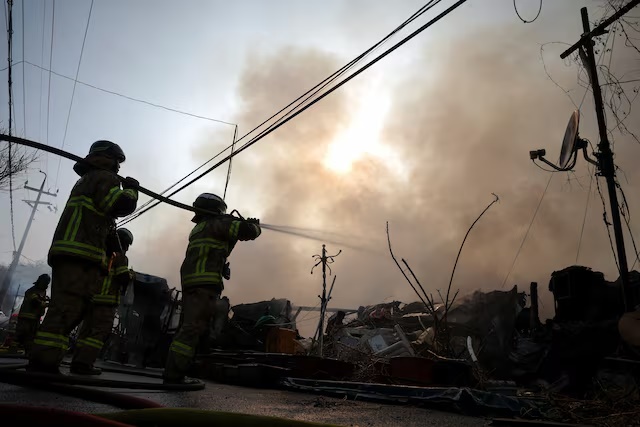 Firefighters work at the scene of a fire at Guryong village, the last shantytown in the Gangnam district, in Seoul, South Korea, January 16, 2026. REUTERS/Kim Hong-ji 