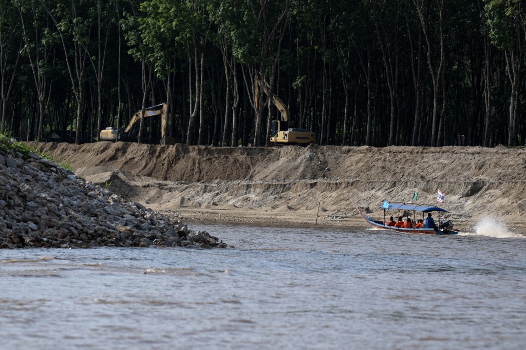 Photo by LILLIAN SUWANRUMPHA / AFP This photo taken on June 5, 2026 shows Buddhist monks taking part in a flotilla to highlight the toxic contamination of rivers affected by gold mining, near the the northern Thai city of Chiang Rai.