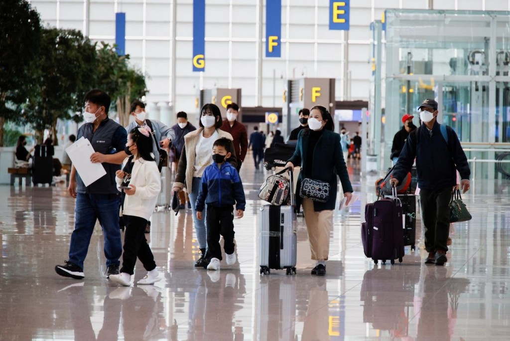 People wearing face masks to prevent contracting from the coronavirus disease (COVID-19) walk at Incheon International Airport in Incheon, South Korea, March 25, 2022. Picture taken March 25, 2022. REUTERS/ Heo Ran