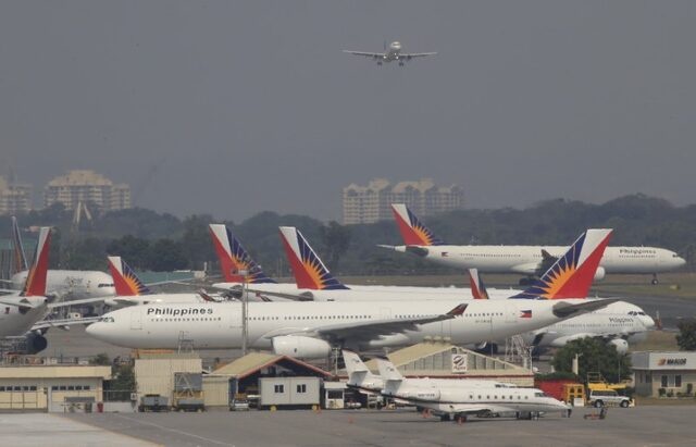 Aircraft of Philippines Airlines (PAL), the southeast asian nation's flag carrier, park beside a hangar at a runway of the Ninoy Aquino International Airport (NAIA) in Manila March 14, 2016. REUTERS/Romeo Ranoco
