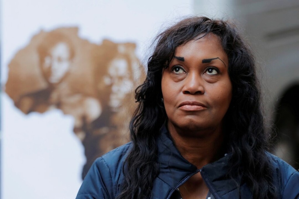Tamara Lanier listens as her lawyer speaks to the media about a lawsuit accusing Harvard University of the monetization of photographic images of her great-great-great grandfather, an enslaved African man named Renty, and his daughter Delia, outside of the Harvard Club in New York, U.S., March 20, 2019. REUTERS/Lucas Jackson/File Photo
