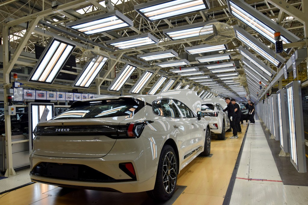 Workers inspect finished Zeekr 001 electric cars at Zeekr's factory in Ningbo, China, April 20, 2025. (Reuters)