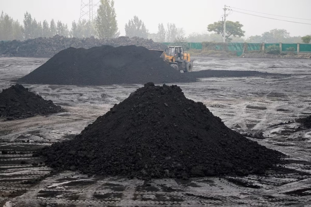 An excavator sift through dunes of low-grade coal near a coal mine in Pingdingshan, Henan province, China November 5, 2021. REUTERS