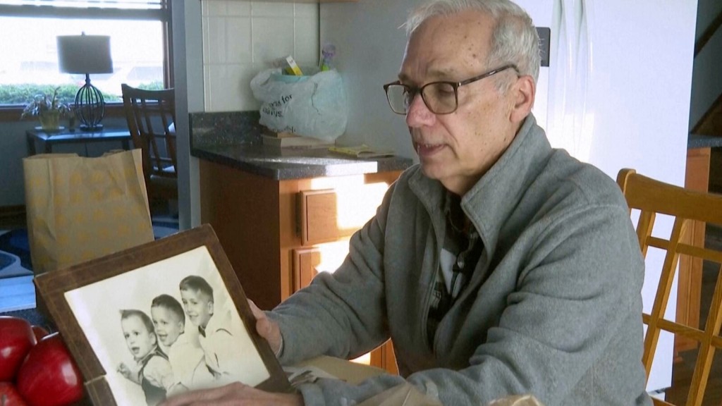 John Prevost points to an old photo of his brothers, including the newly elected Pope Leo XIV, Robert Prevost, left, during an interview with the Associated Press on Thursday, May 8, 2025, in New Lennox, Ill. (AP Photo/Obed Lamy)