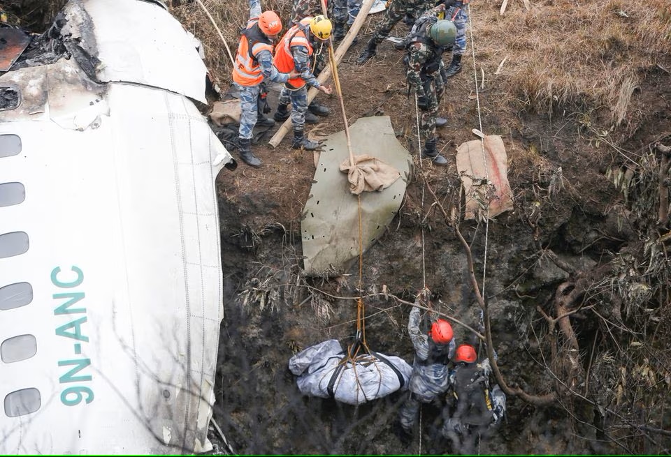 A rescue team recovers the body of a victim from the site of the plane crash of a Yeti Airlines operated aircraft, in Pokhara, Nepal. (Reuters) A rescue team recovers the body of a victim from the site of the plane crash of a Yeti Airlines operated aircraft, in Pokhara, Nepal. (Reuters)