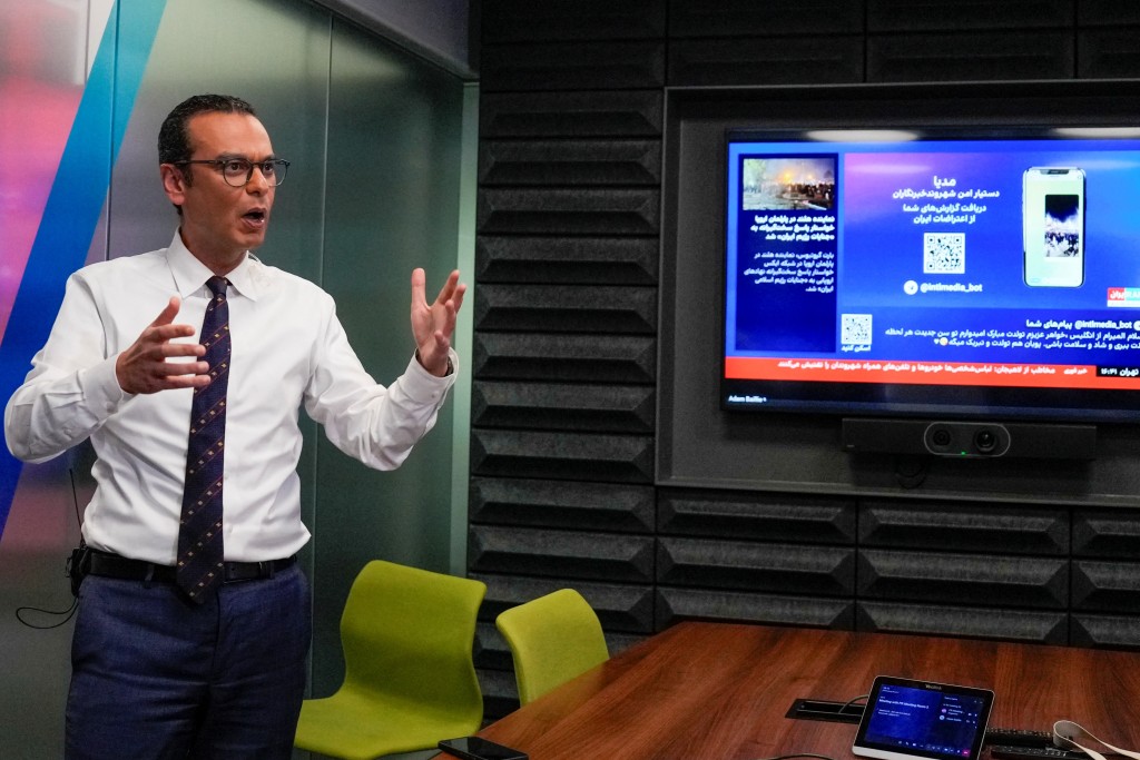 Photo by CARLOS JASSO / AFP  This photo taken on January 20, 2026 shows Reza Mohaddes, a presenter and editor-in-chief for Iran International, speaking during an interview with AFP in London.